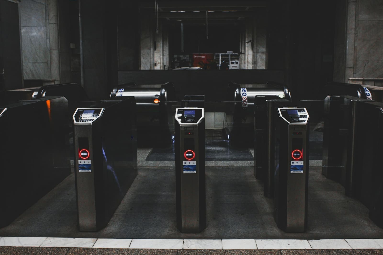 A row of turnstiles with red no-entry signs on their displays