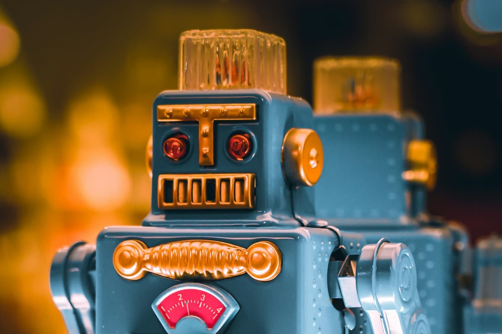 Two vintage tin toy robots, close up