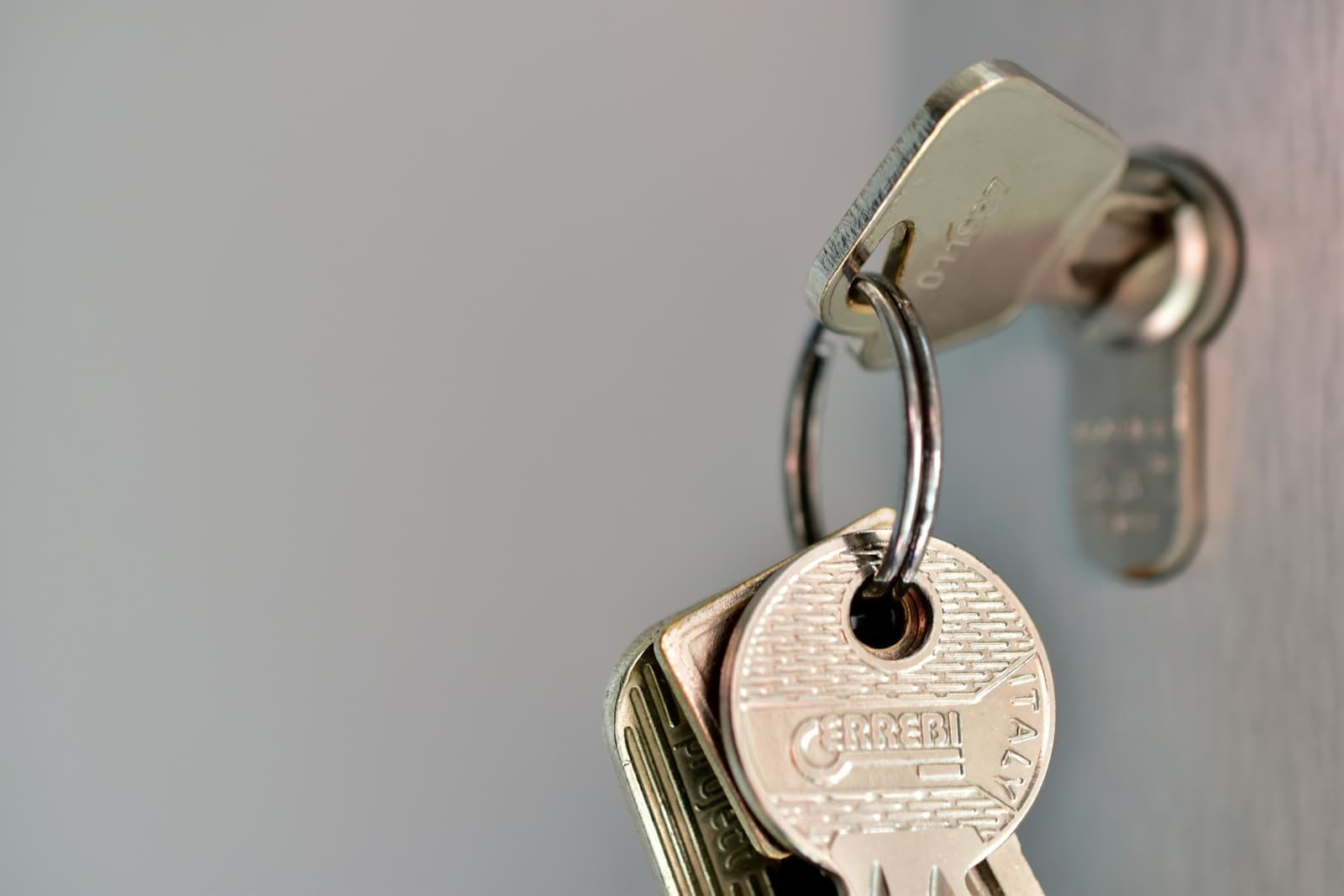 A bunch of keys hanging from a key left in a lock