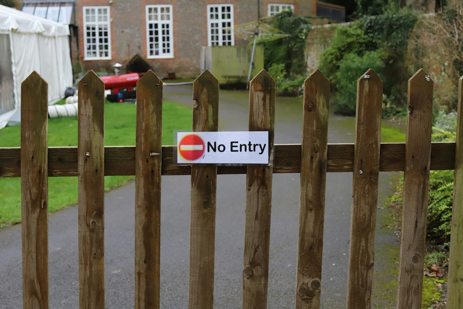 A wooden gate with a “No Entry” sign